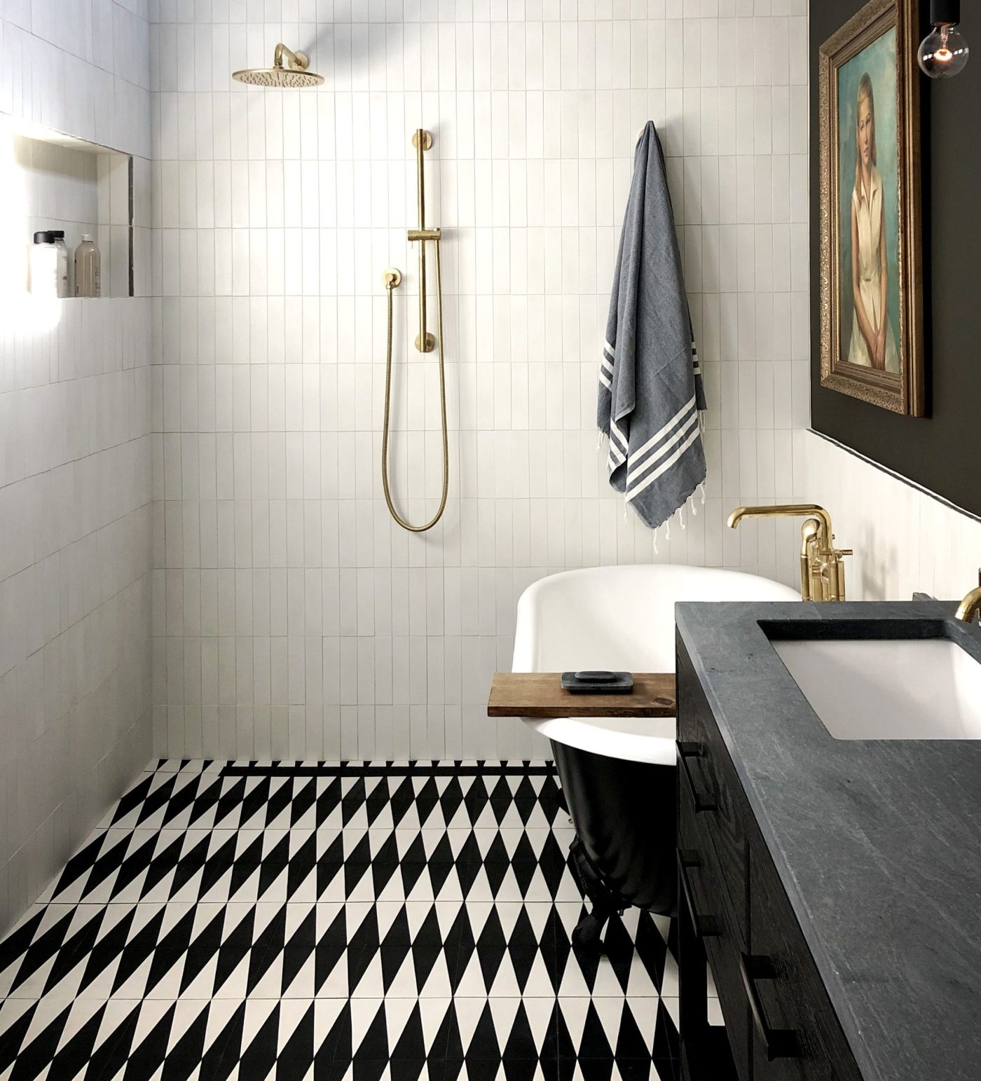 a bathroom with a black and white patterned tile floor.