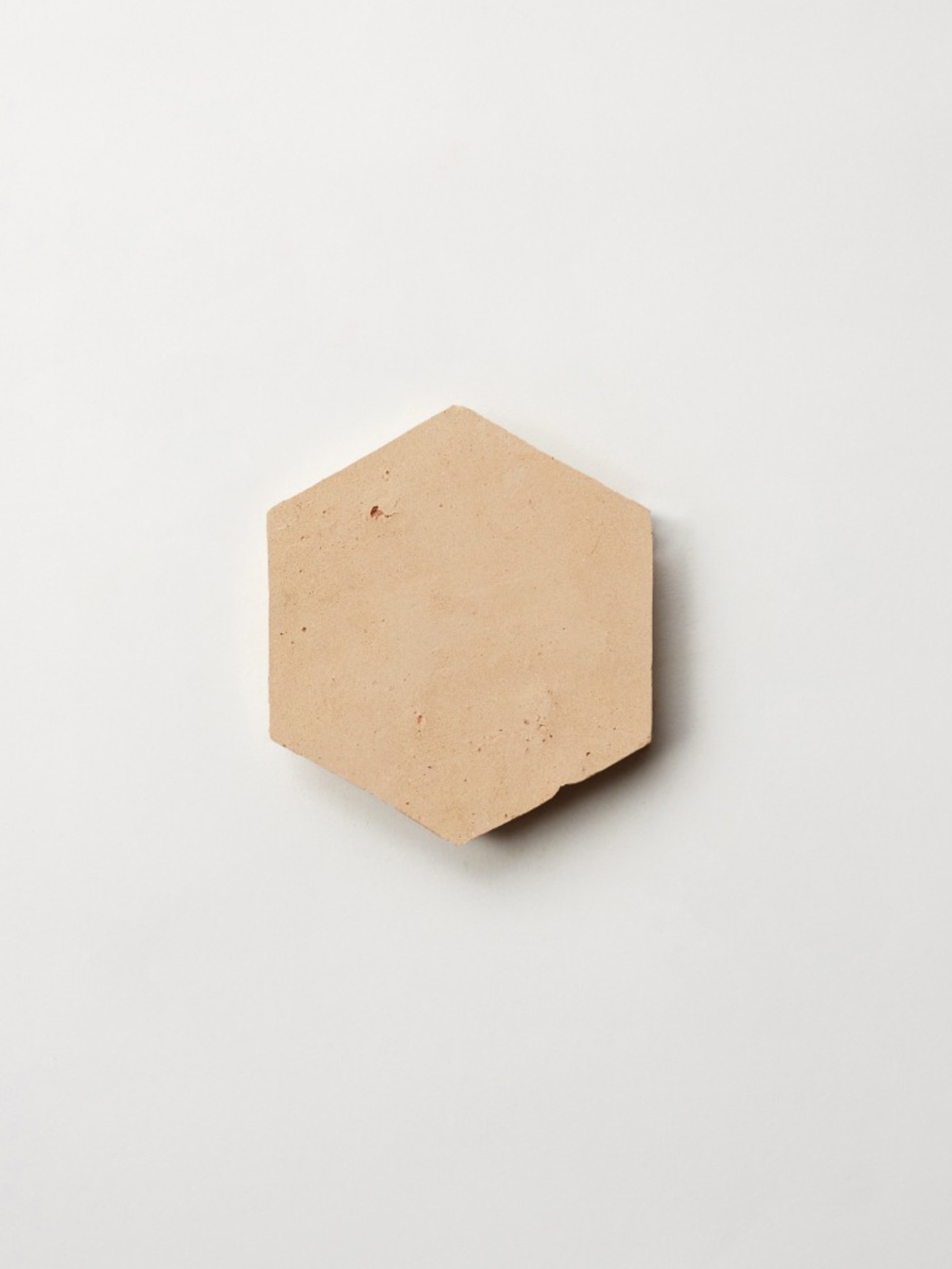 a beige hexagonal tile on a white background.