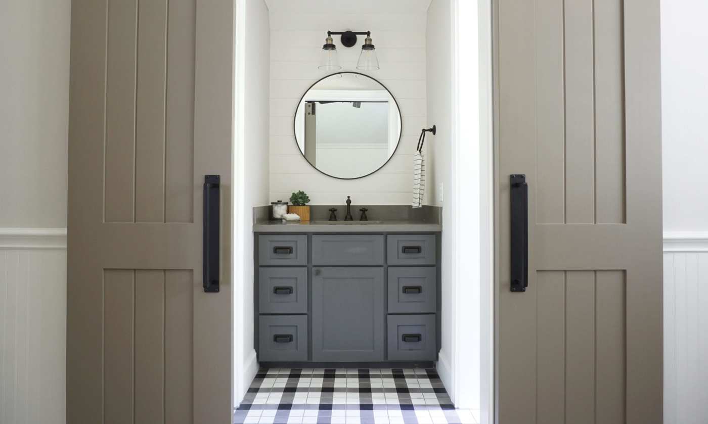 a bathroom with a black and white checkered floor.