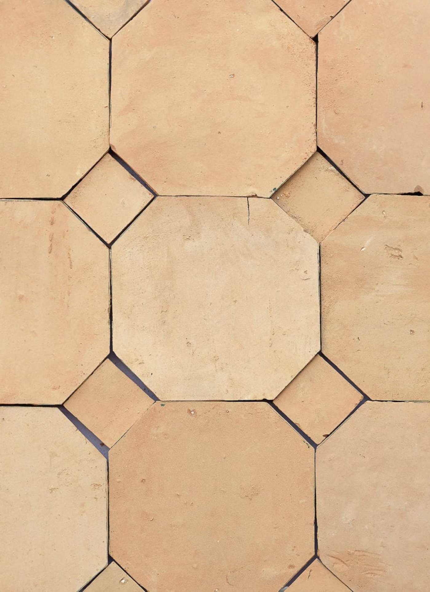 a close up of a tile floor with a hexagonal pattern.