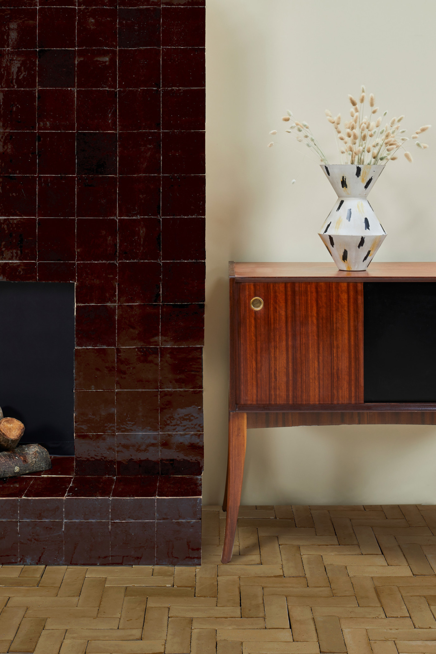 a brown tiled fireplace in a room.