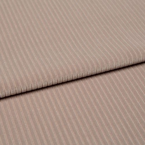 Ribbed beige corduroy fabric, folded into two layered panels showing parallel ridges, photographed close-up on a neutral surface with soft, even studio lighting.