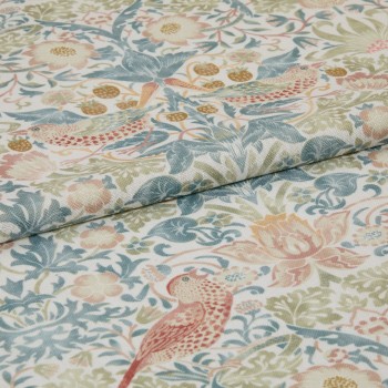 Folded printed fabric with pastel floral and bird motif and visible linen texture lies folded across itself, close-up on a flat surface in soft, diffuse light.