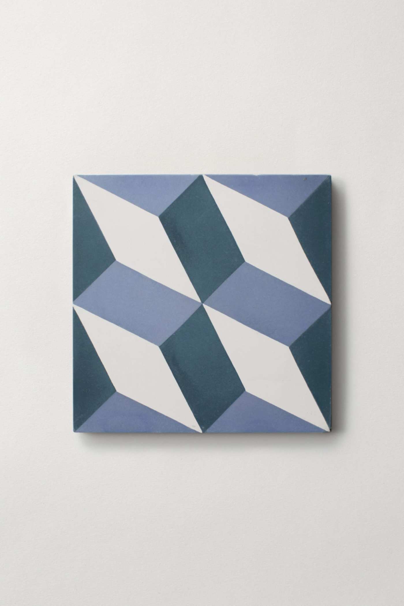 a blue and white tile on a white background.