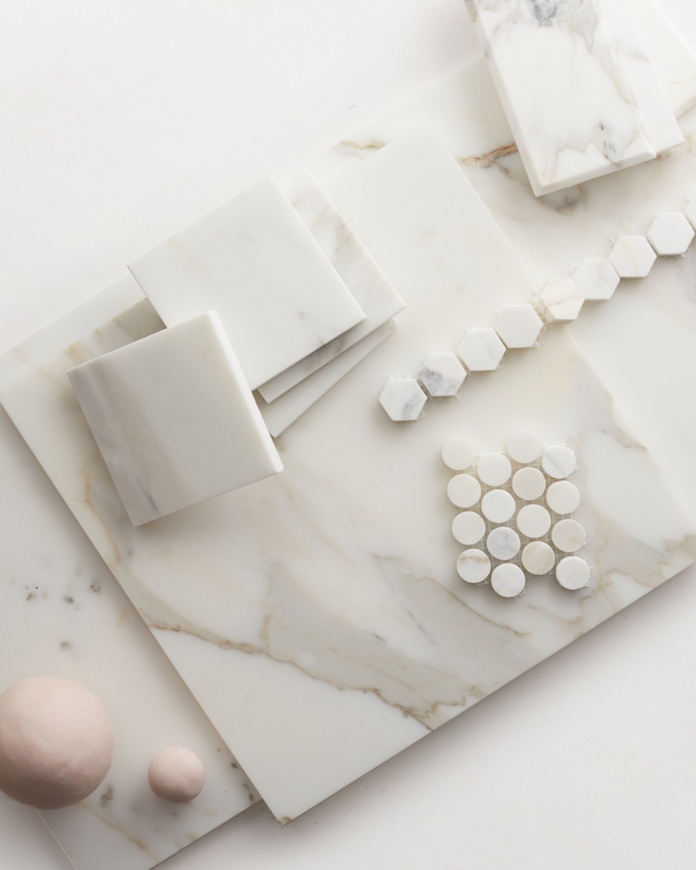 various shapes of white marble tile on a white surface.