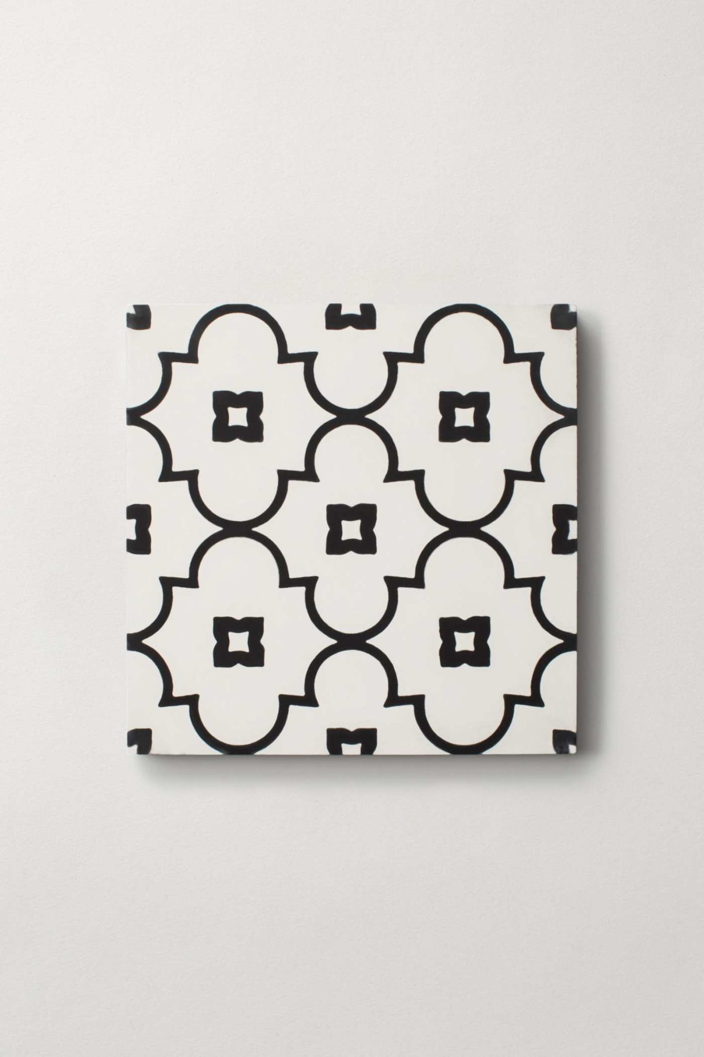 a black and white patterned tile on a white surface.