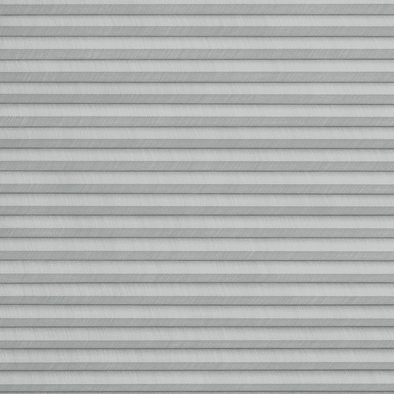 Gray pleated cellular blinds, fully lowered with horizontal fabric cells and subtle texture; closed and filtering diffuse daylight; covering an interior window in a softly lit room, no view visible.