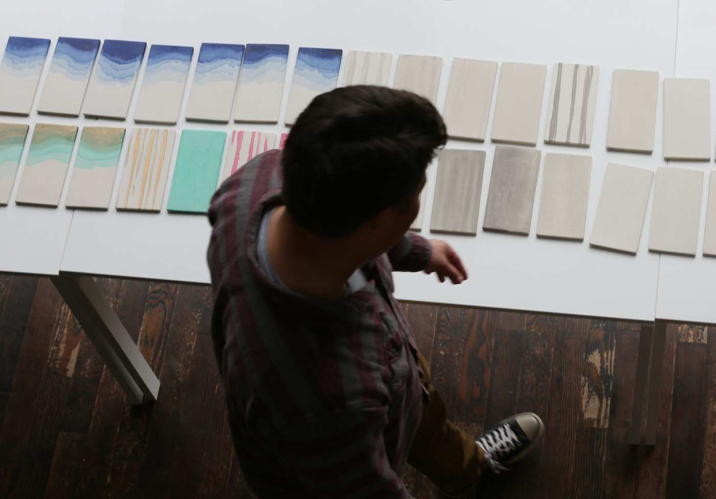 a man standing in front of a white table.