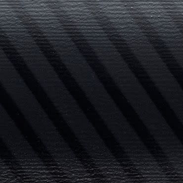 Venetian blind slats casting diagonal dark stripes across a textured black surface, filtering soft light in a dim, close-up scene with subtle grain and low contrast.