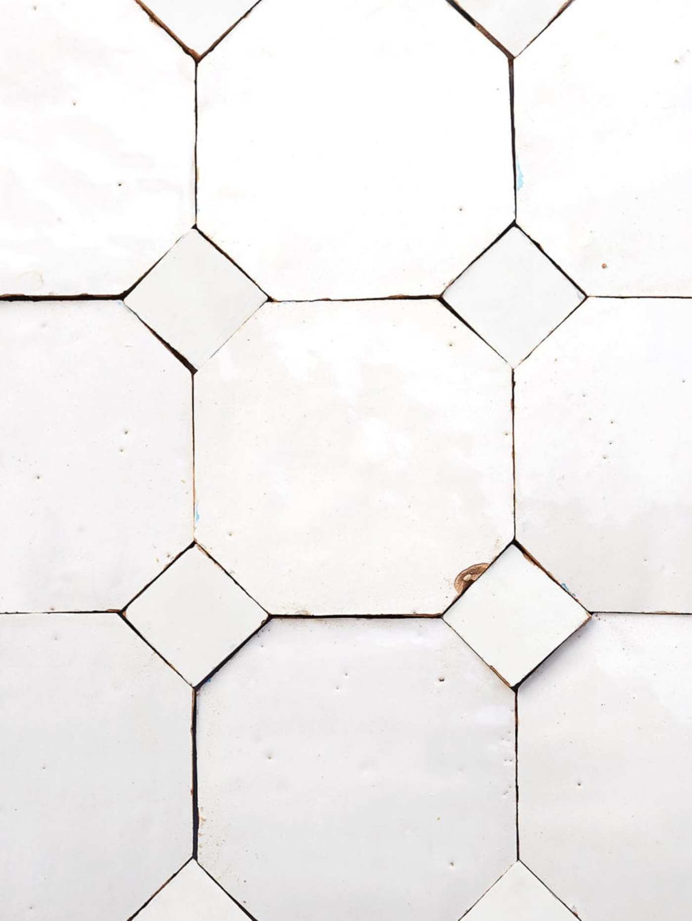 a close up image of a white tile with white hexagons.