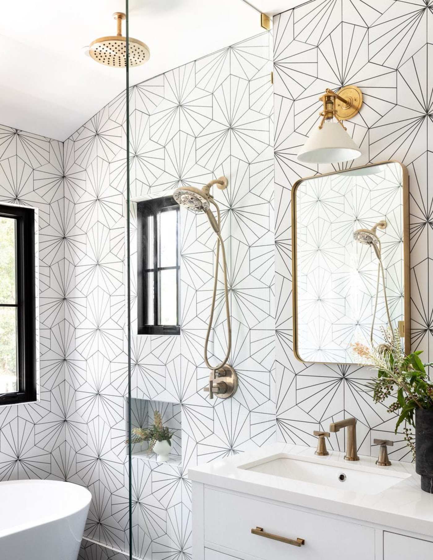 a bathroom with a black and white tiled wall.