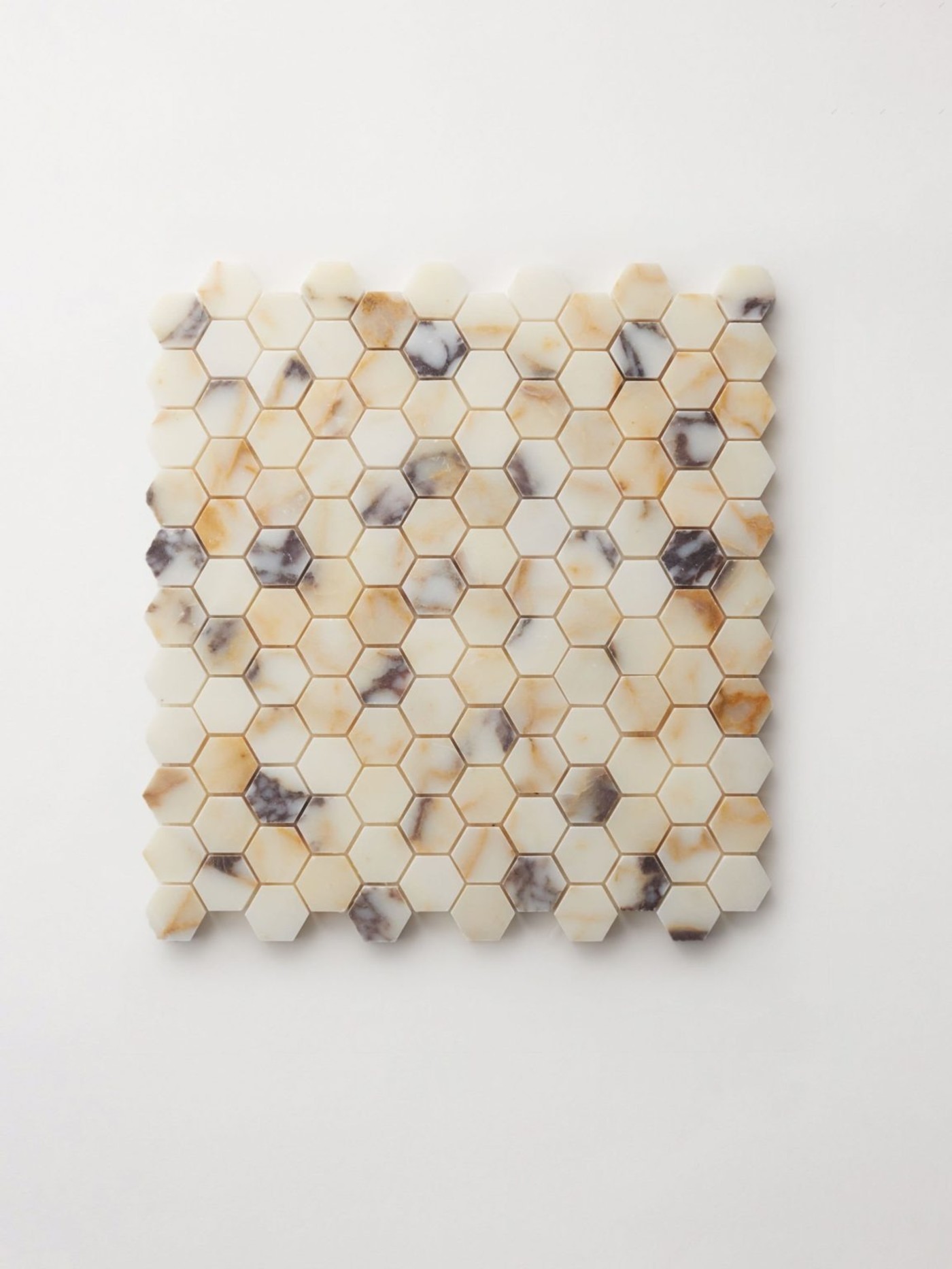 a hexagonal mosaic tile on a white surface.