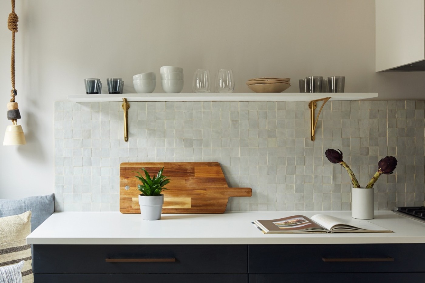 a kitchen counter with a white tile backsplash.