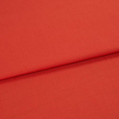 Red woven fabric panel with visible fine texture, folded across the frame forming a horizontal overlap; lying flat under soft, even studio lighting with no other objects or background details.