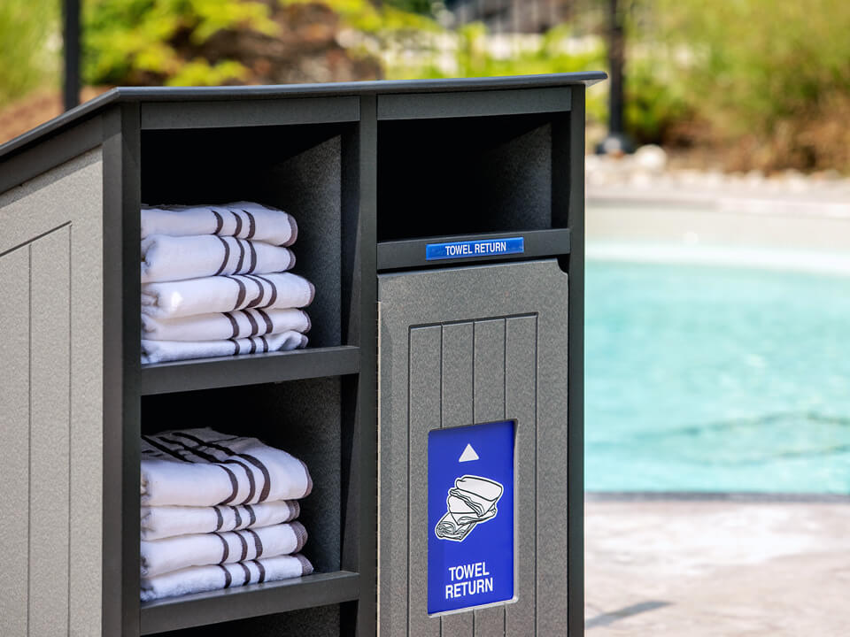 recycled plastic towel collection bin for pools and recreation facilities outside at a private community pool