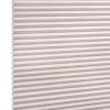 Cellular honeycomb window blind (light pink/beige) with horizontal pleats, fully lowered and closed, blocking light; close-up product shot against a white background.