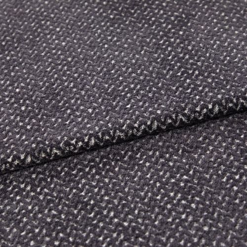 Folded dark gray woven fabric (small white flecked texture) — layered edge overlapping — close-up studio view highlighting soft pile and subtle zigzag pattern.