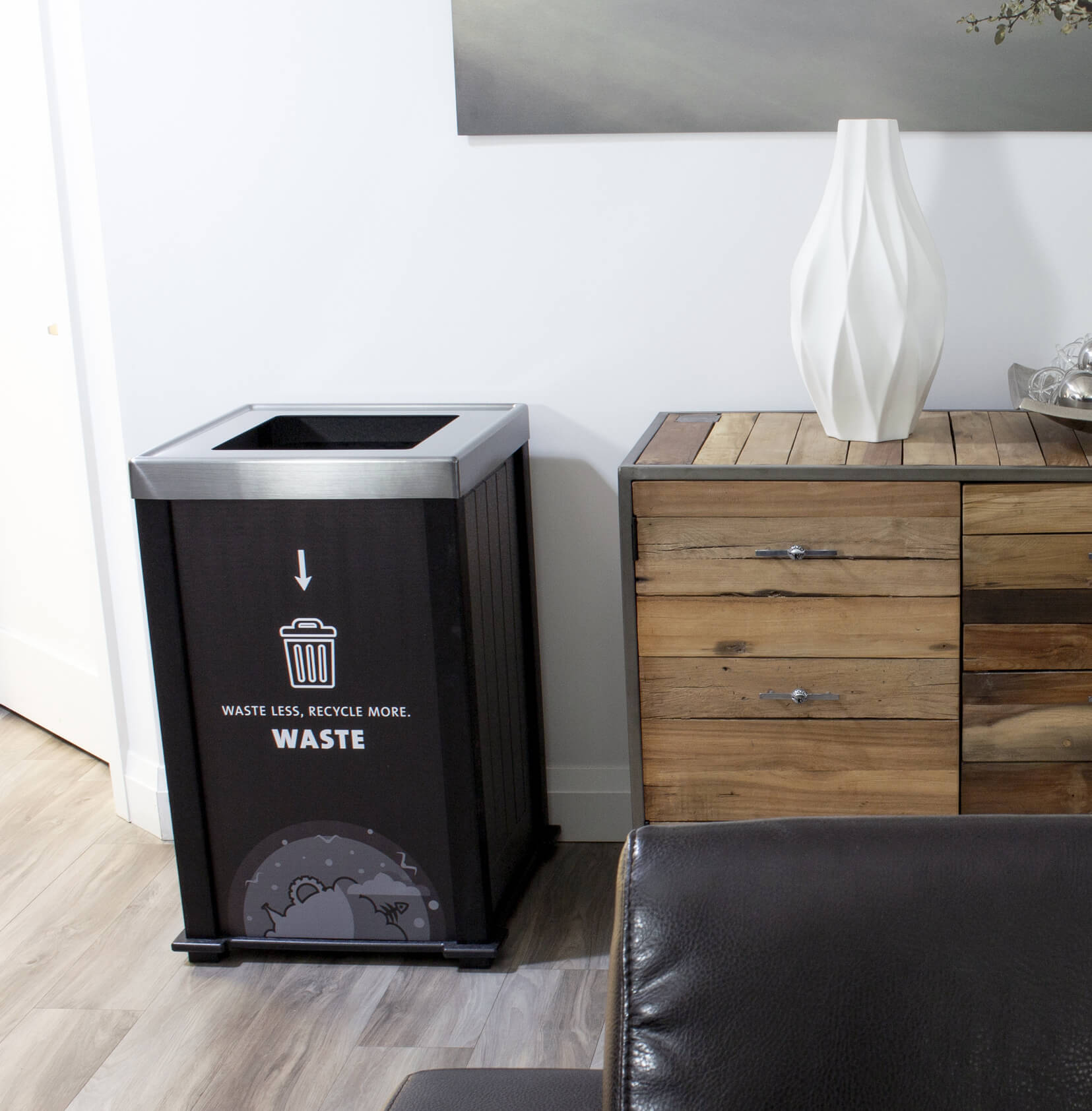 black waste container with a body sign in an office space