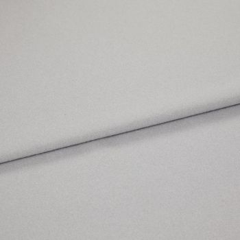 Light gray, soft-textured fabric folded diagonally across the frame, creating an overlapping edge; close-up view with diffuse, even lighting on a neutral background.