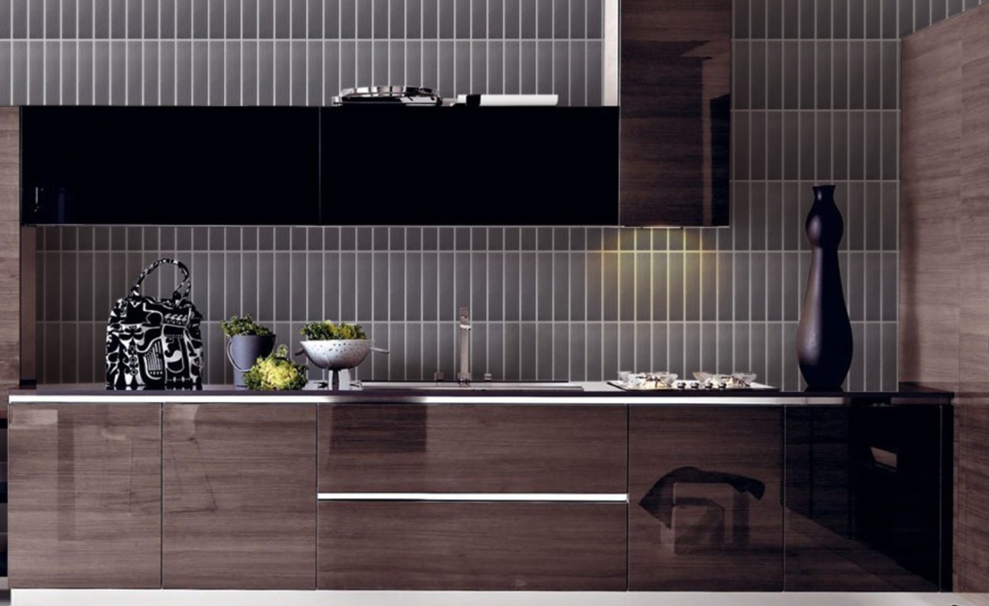 a modern kitchen with black and brown cabinets.