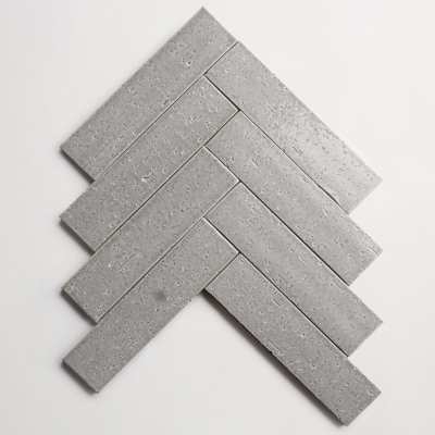 a grey herringbone tile on a white background.