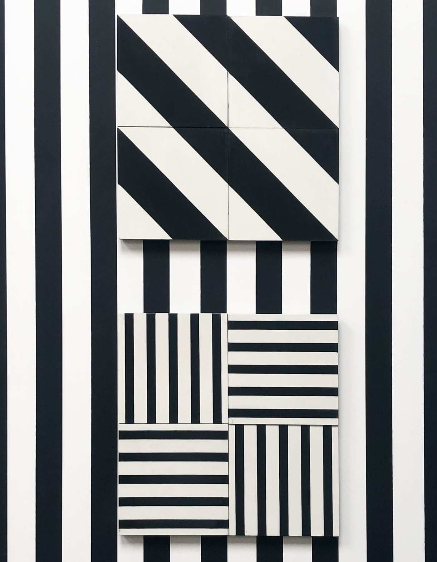 black and white striped tiles on a wall.