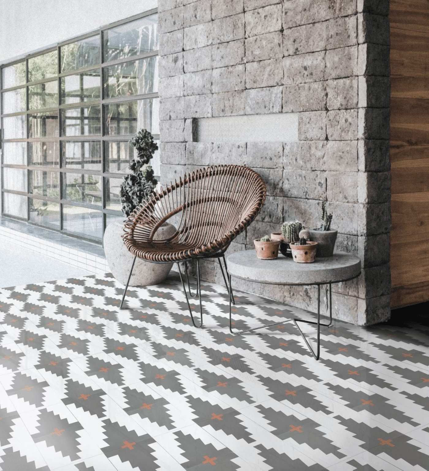 a room with a tiled floor and a wicker chair.