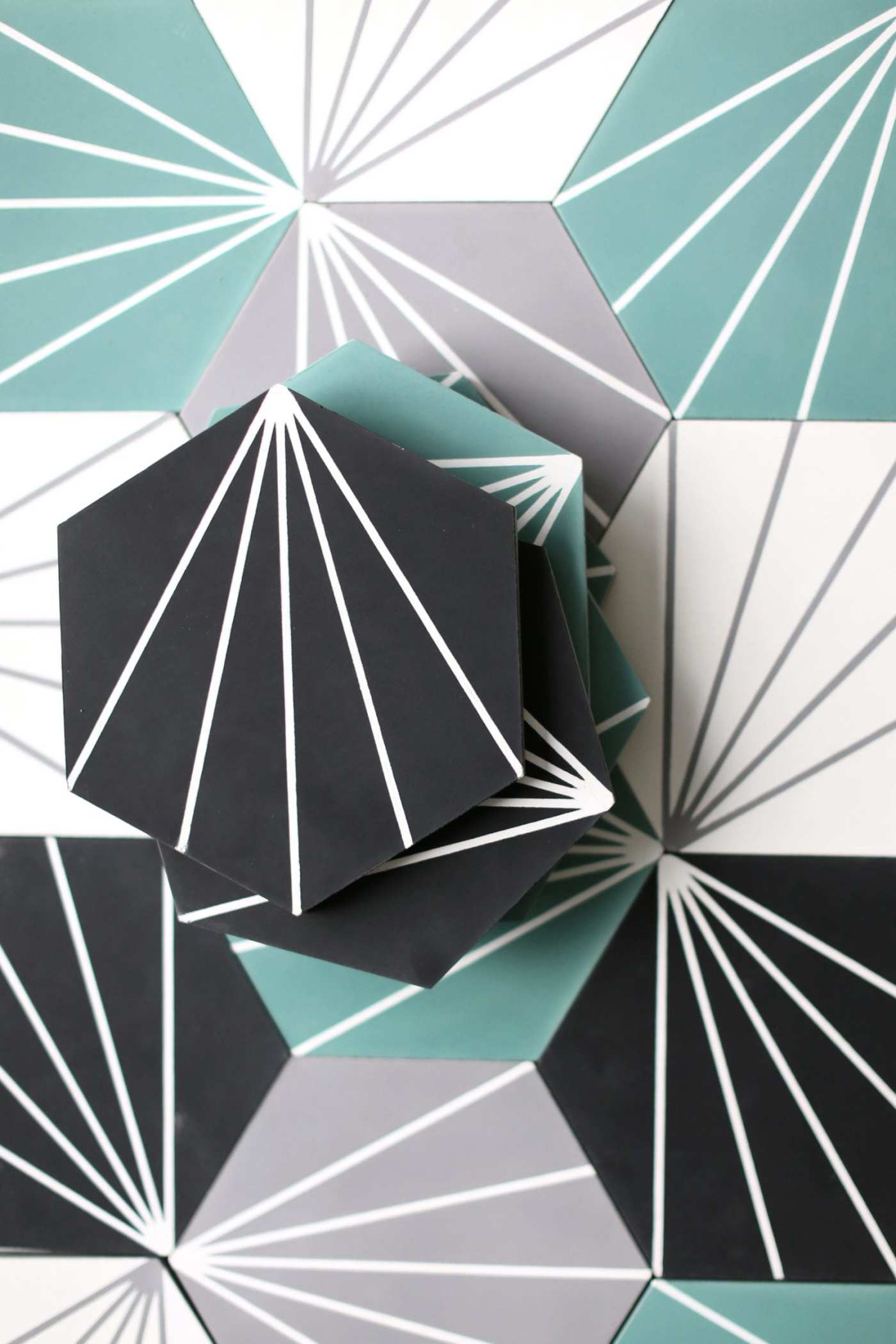 a group of black, white, and teal tiles with geometric designs on them.