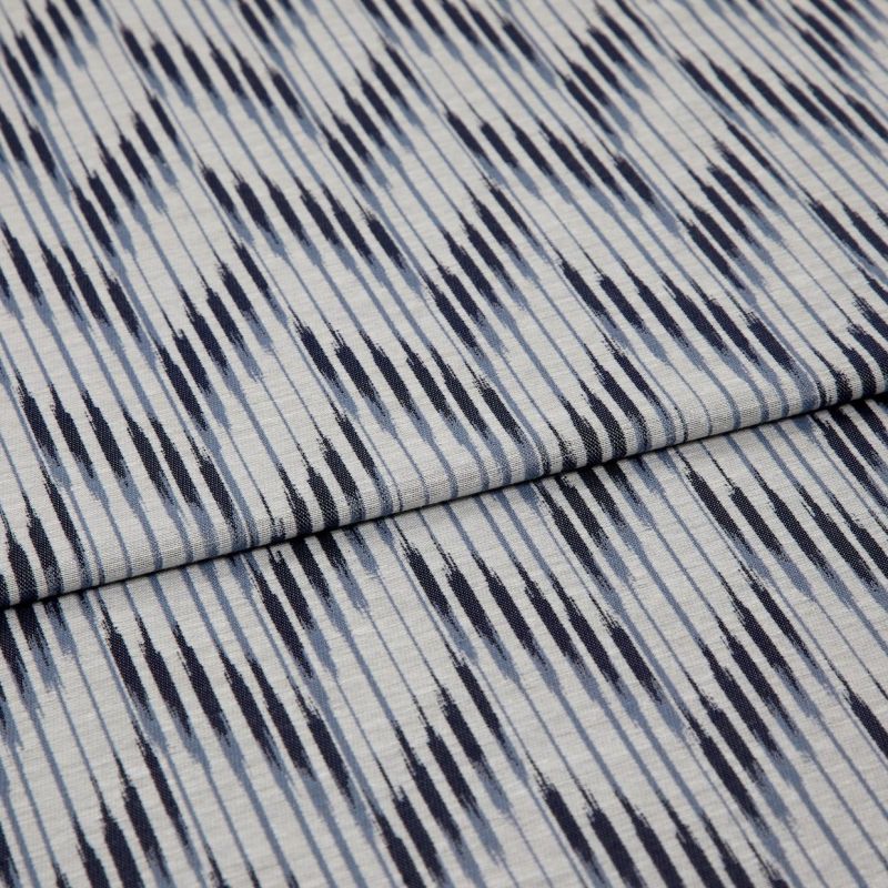 Woven cotton fabric with irregular navy and pale-blue vertical stripes, folded once across the middle; close-up view on a flat surface, evenly lit, showing texture and subtle creases.