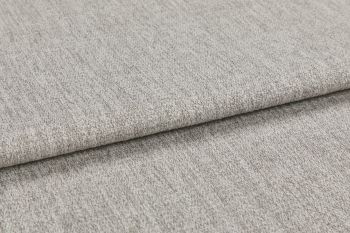 Woven light gray fabric folded in overlapping layers, showing subtle texture and flecked yarns; photographed close-up with soft, even studio lighting on a neutral surface.