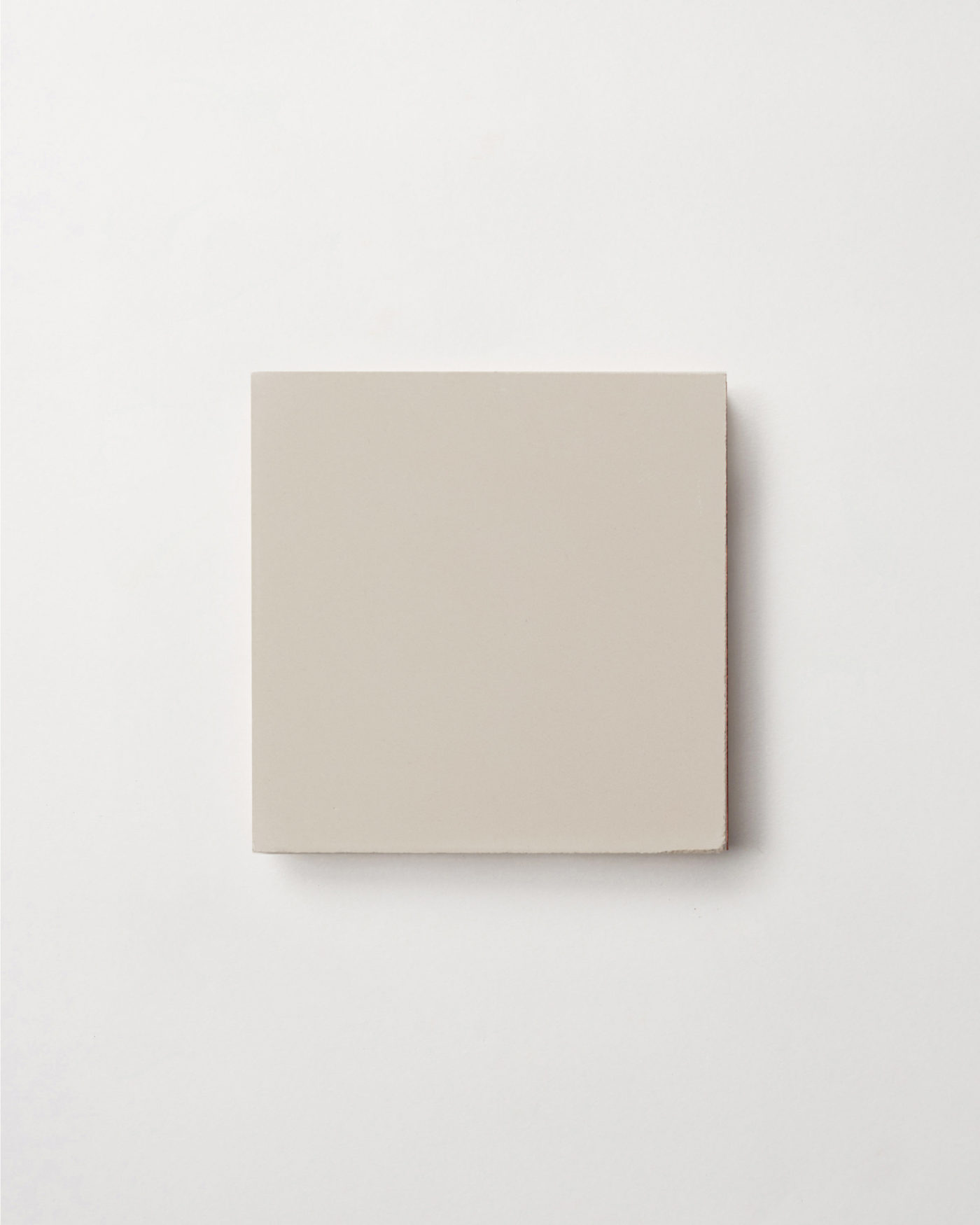 a beige square tile on a white background.