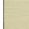 Cellular (honeycomb) window shade, lowered and closedâ€”beige pleated fabric with visible black hexagonal cell edges at leftâ€”softly filtering light, shown against a plain white background.
