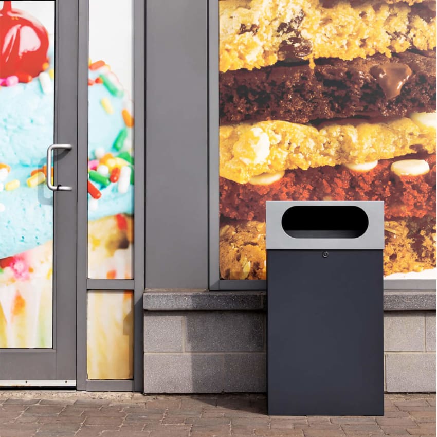 all metal powder coated outdoor waste bin with sloped lockable lid outside of a dessert restaurant