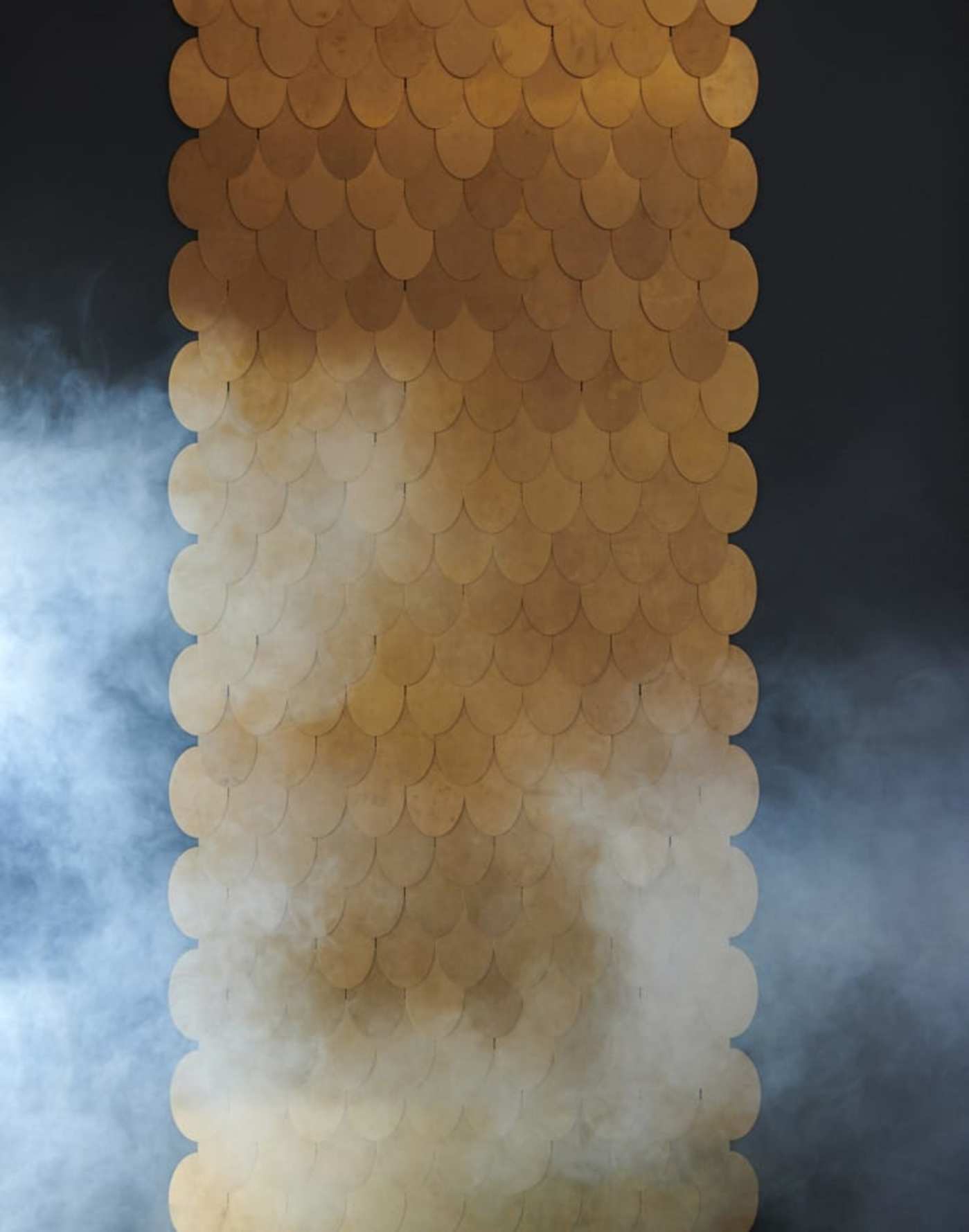 an image of a gold plated wall with smoke coming out of it.