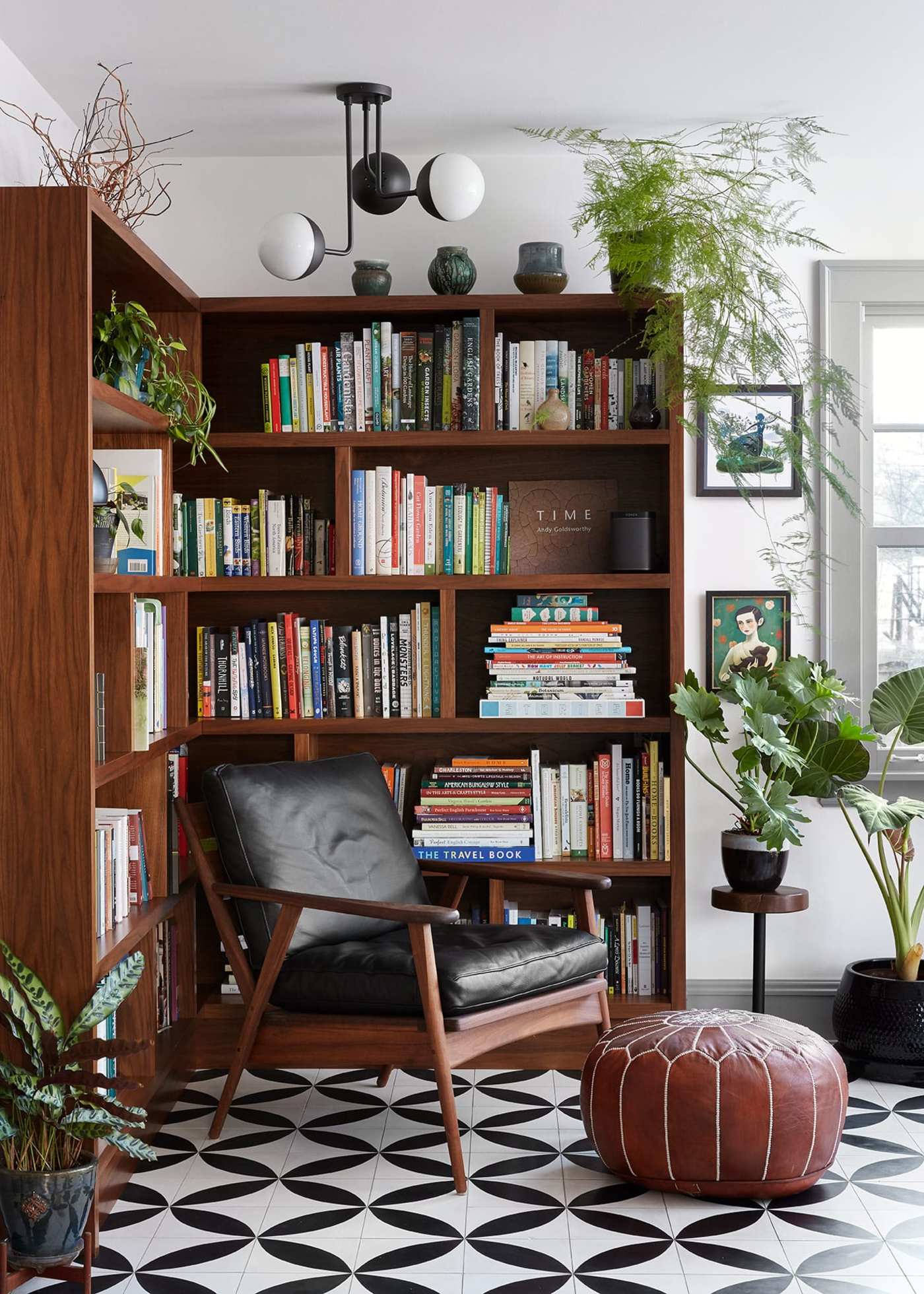 a living room with bookshelves on a black and white patterned floor.