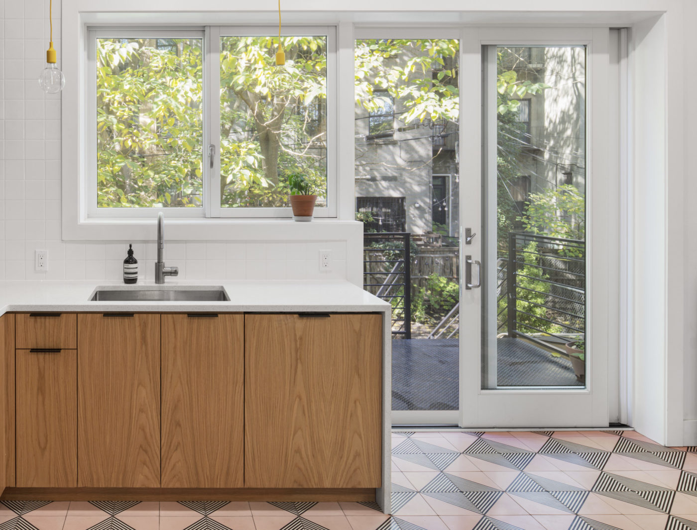 a kitchen with a sink and a door to the outside.