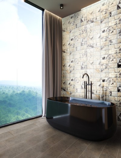 a bathroom with a black tub and tiled walls.