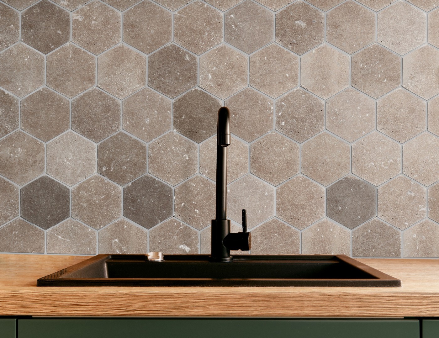 a kitchen with a hex tiled backsplash and a sink.