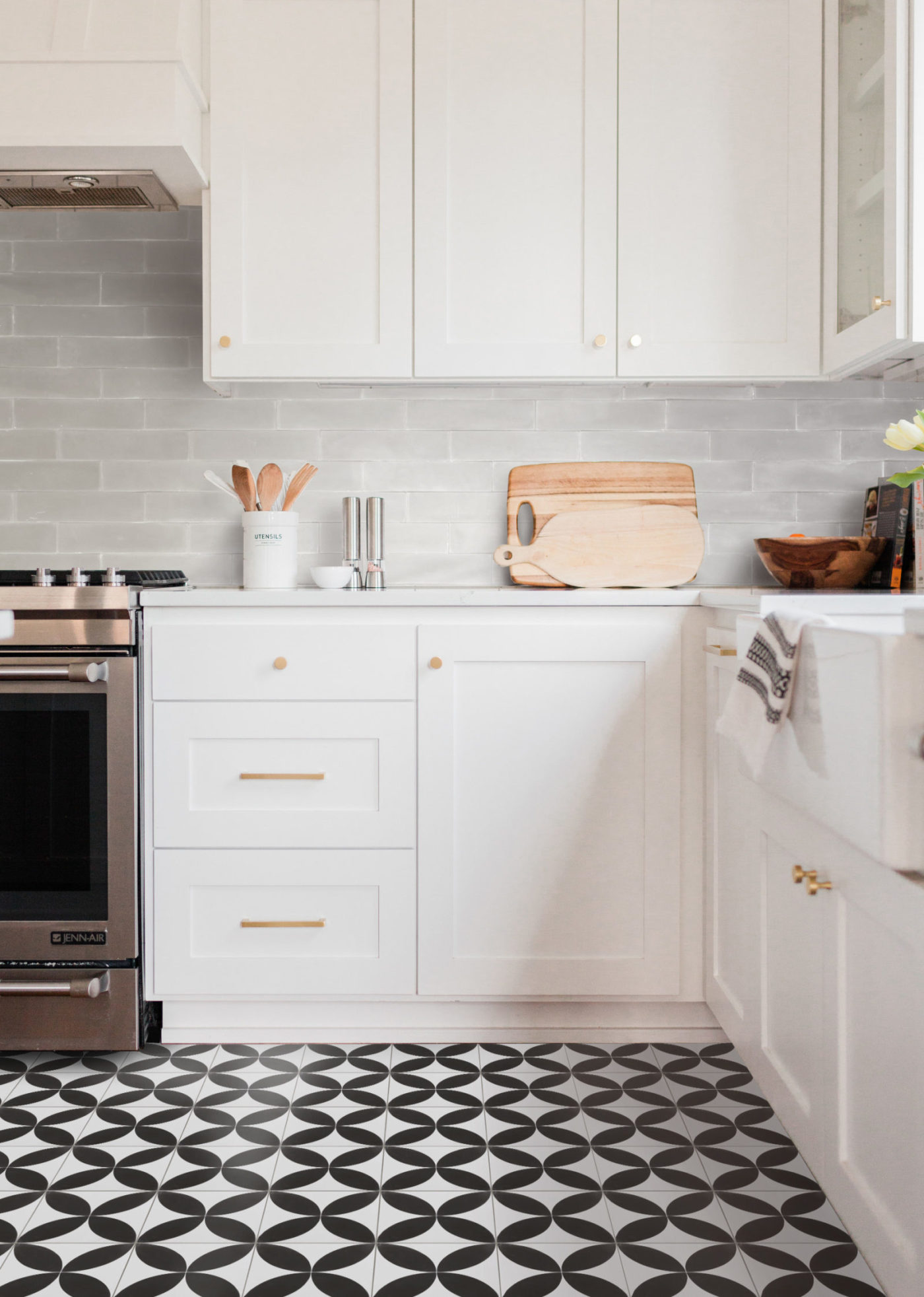 a black and white tiled floor in a kitchen.