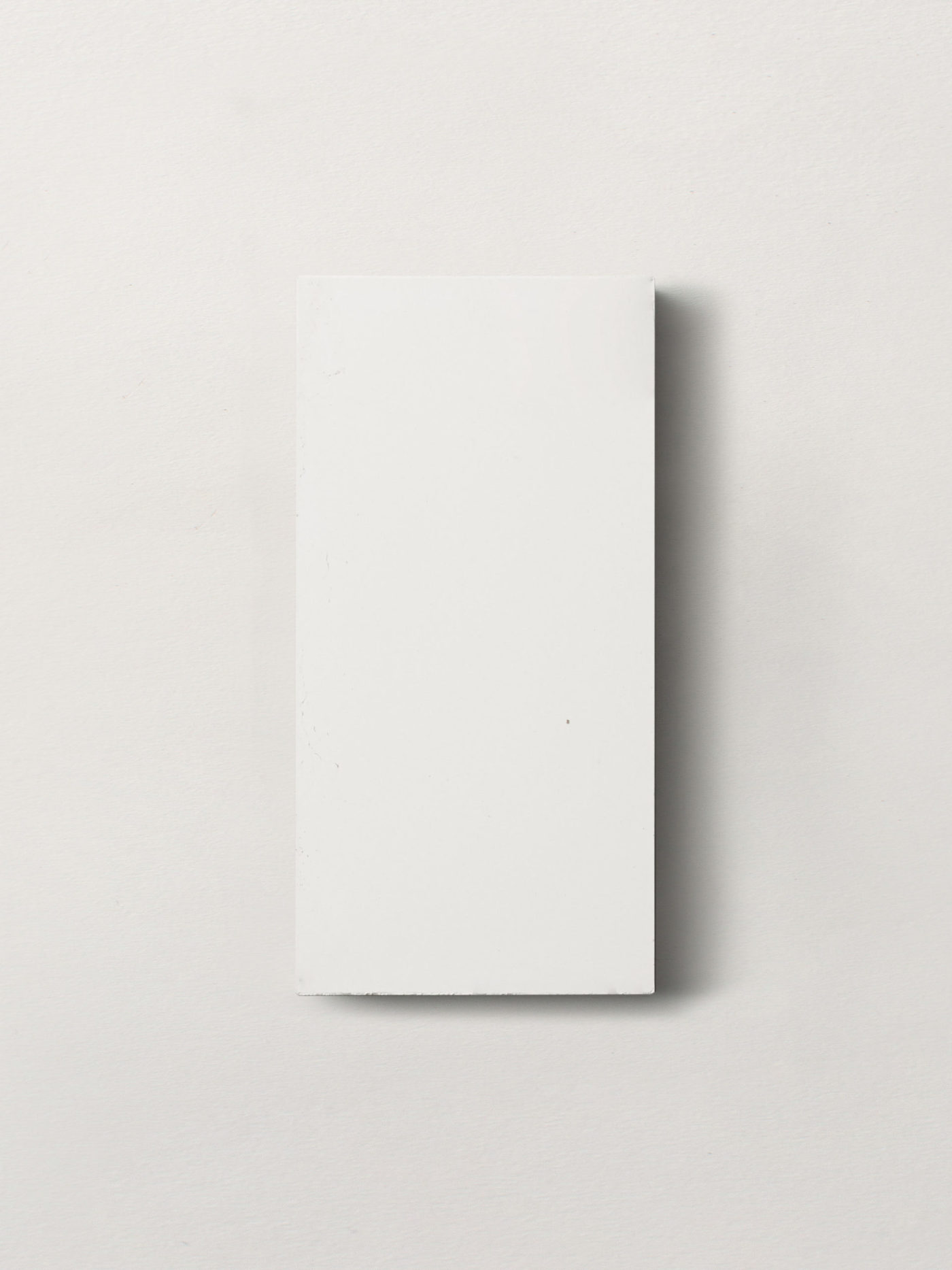 a white rectangle tile on a white background.