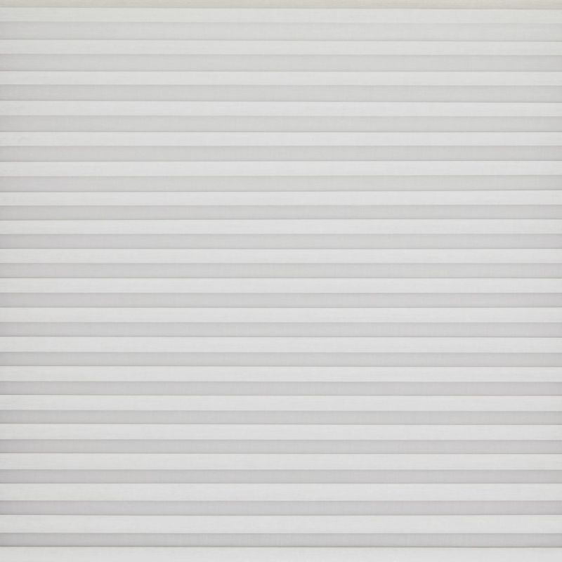 White horizontal pleated blinds covering the entire window, narrow evenly spaced slats; closed and softly diffusing daylight; set against a neutral wall in a bright, minimal interior.