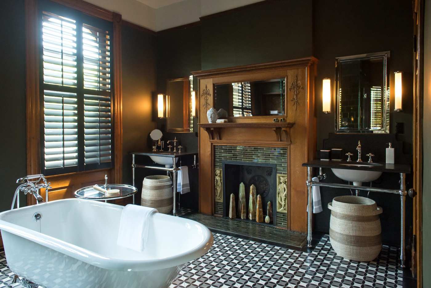 a black and white bathroom with a bathtub and fireplace.