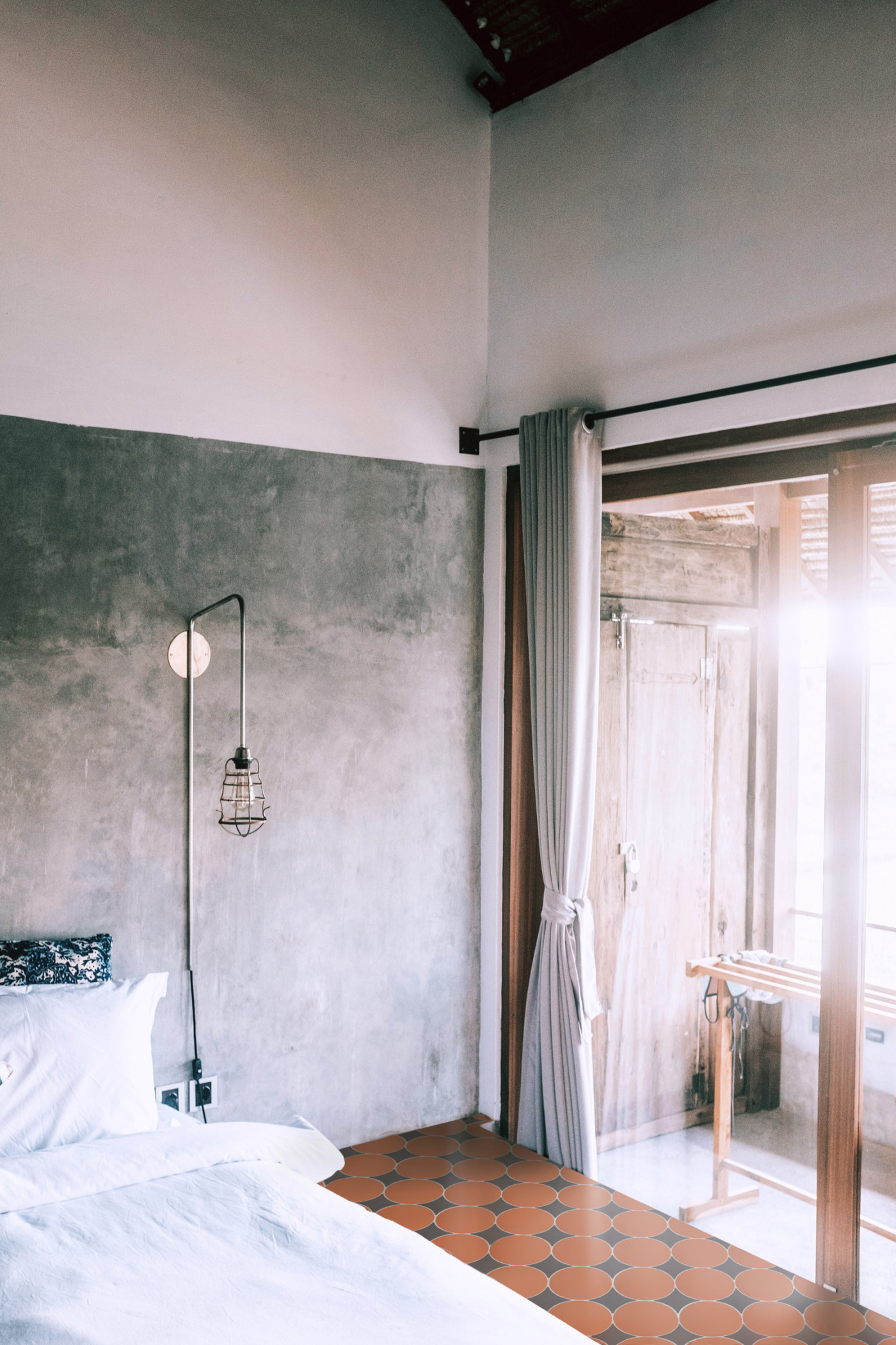 a bedroom with a bed and a sliding glass door.