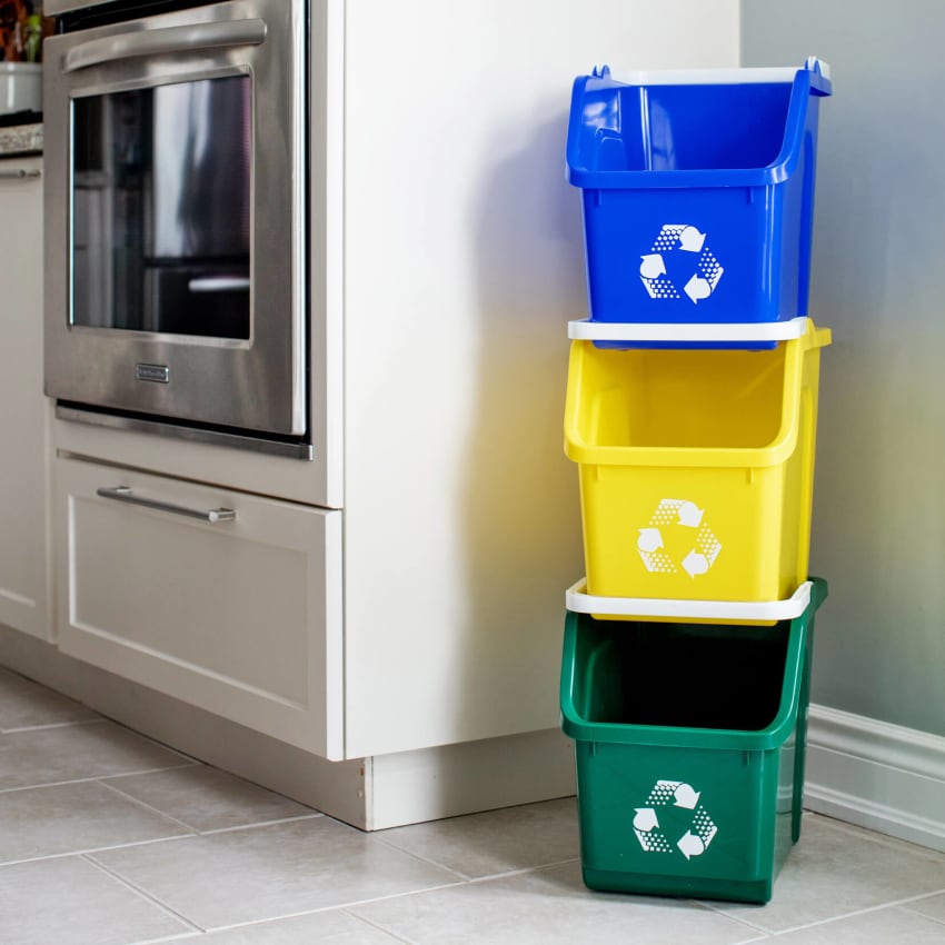 stack of three blue yellow and green recycling containers perfect for tight spaces in a kitchen beside the oven