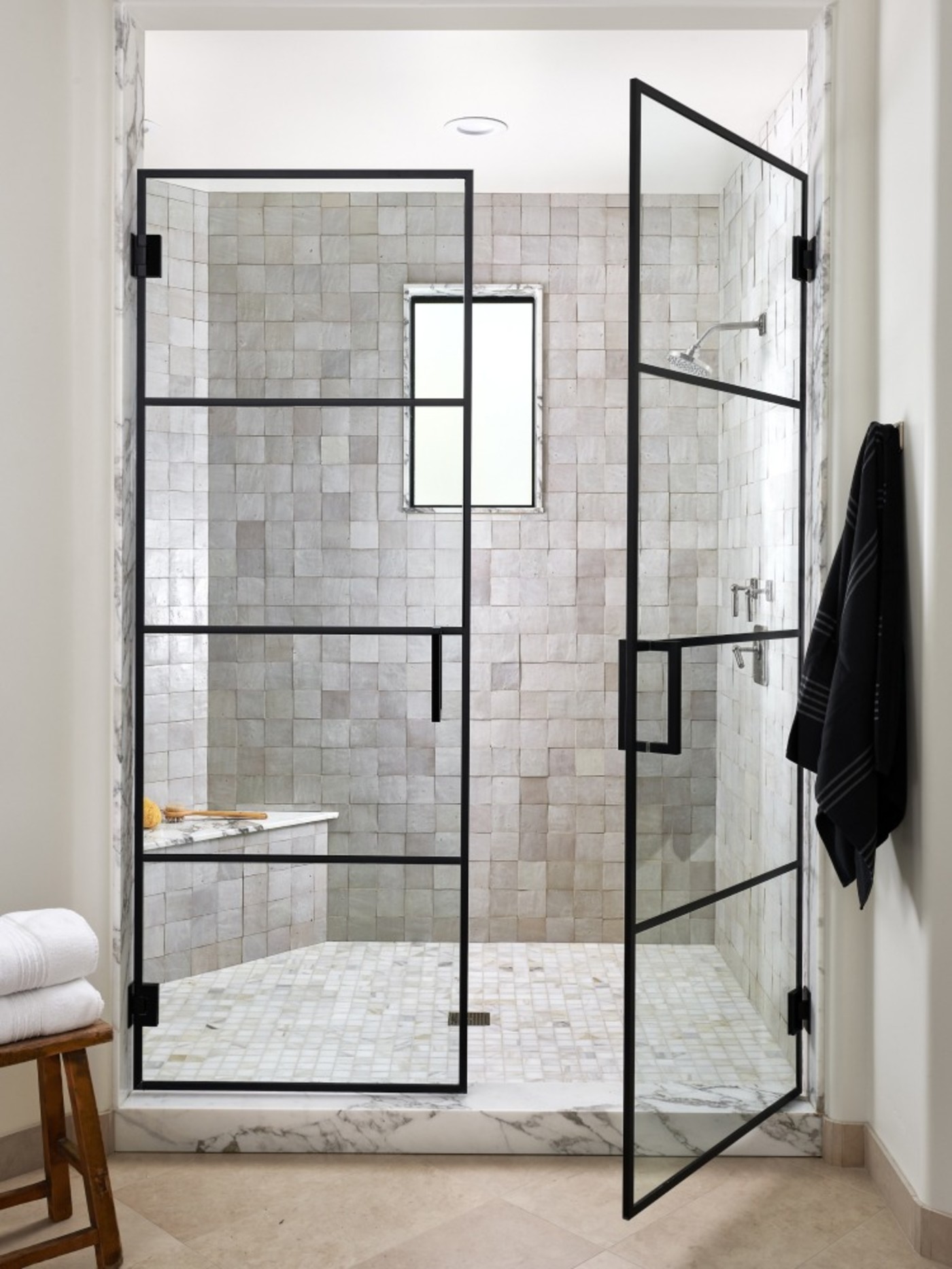 a bathroom with a glass shower door.