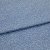 Blue fabric with dense, irregular white dot pattern, folded across the frame; lying flat and slightly overlapped, photographed close-up under soft, even studio lighting for a textile product shot.