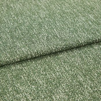 Folded green boucle upholstery fabric with white flecks, layered one fold over another; resting flat and revealing textured weave, photographed close-up under soft neutral studio lighting.