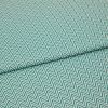 Folded teal-and-white chevron fabric (zigzag pattern) — folded once forming a horizontal seam — close-up, evenly lit textile filling the frame, showing texture and repeating geometric pattern.