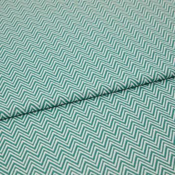 Folded teal-and-white chevron fabric (zigzag pattern) â€” folded once forming a horizontal seam â€” close-up, evenly lit textile filling the frame, showing texture and repeating geometric pattern.