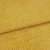 golden-yellow textured upholstery fabric folded diagonally, overlapping seam visible; short plush pile creates a mottled sheen, presented in a tight close-up under soft, even studio lighting.